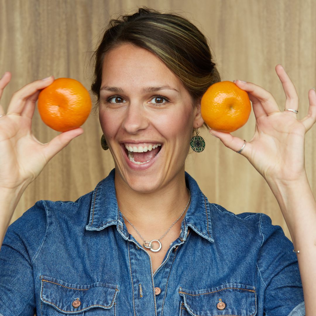 vegan diet coach with fruit in her hand
